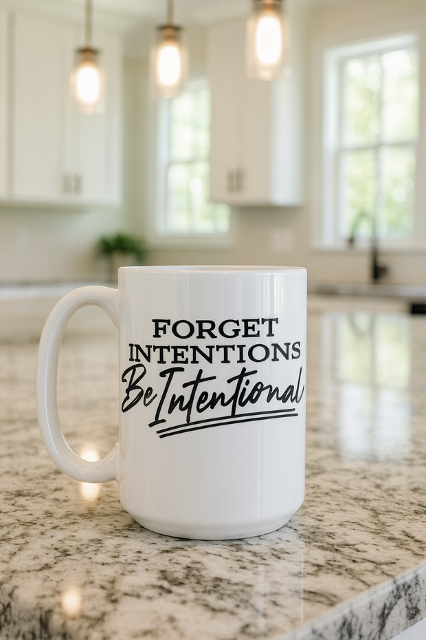 White mug with 'Forget Intentions Be Intentional' text on a kitchen counter.